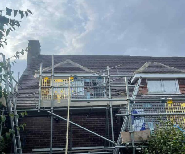 This is a photo of a roof with two dormers that is having some damaged tiles replaced. Works carried out by LNM Roofing Featherstone