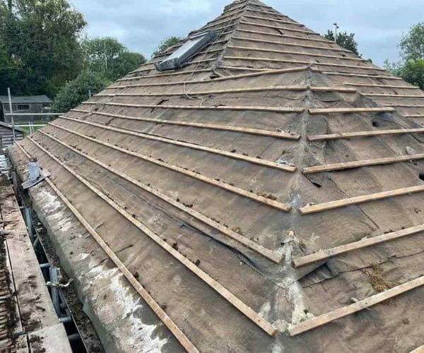 This is a photo of a hip roof that has been stripped back to the battens, and is awaiting a new roof covering to be installed. Works carried out by LNM Roofing Featherstone